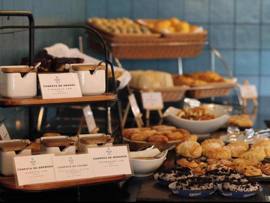 A buffet with various food items and labeled containers of compotes.