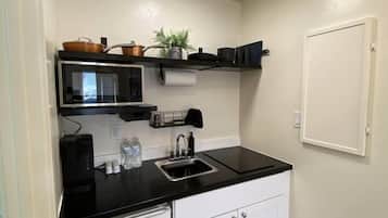 Fridge, microwave, coffee/tea maker, cookware/dishes/utensils