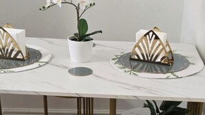 A marble-topped table with two gold and white paperweights and a potted orchid. - 1 Bed - Sleeps 4 - City Centre (Wolverhampton)