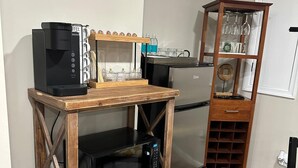 A compact kitchenette with a coffee maker, microwave, and wine rack. - Home away from home with WiFi and AC in delightful Parkville (Parkville)