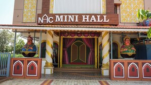 The exterior of NAIc Mini Hall with a traditional architectural design, including ornate decorations and a prominent entrance. - HOTEL N N PALACE (Thanjavur)