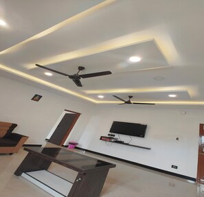 Premium Room | Living area | 32-inch LCD TV with cable channels - The Canalway Inn (Pollachi)