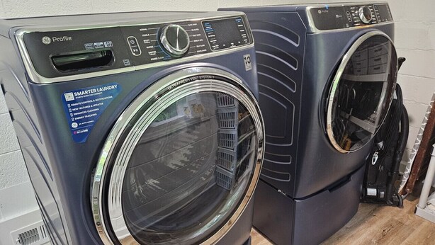 Two front-loading washing machines with digital displays and control panels.