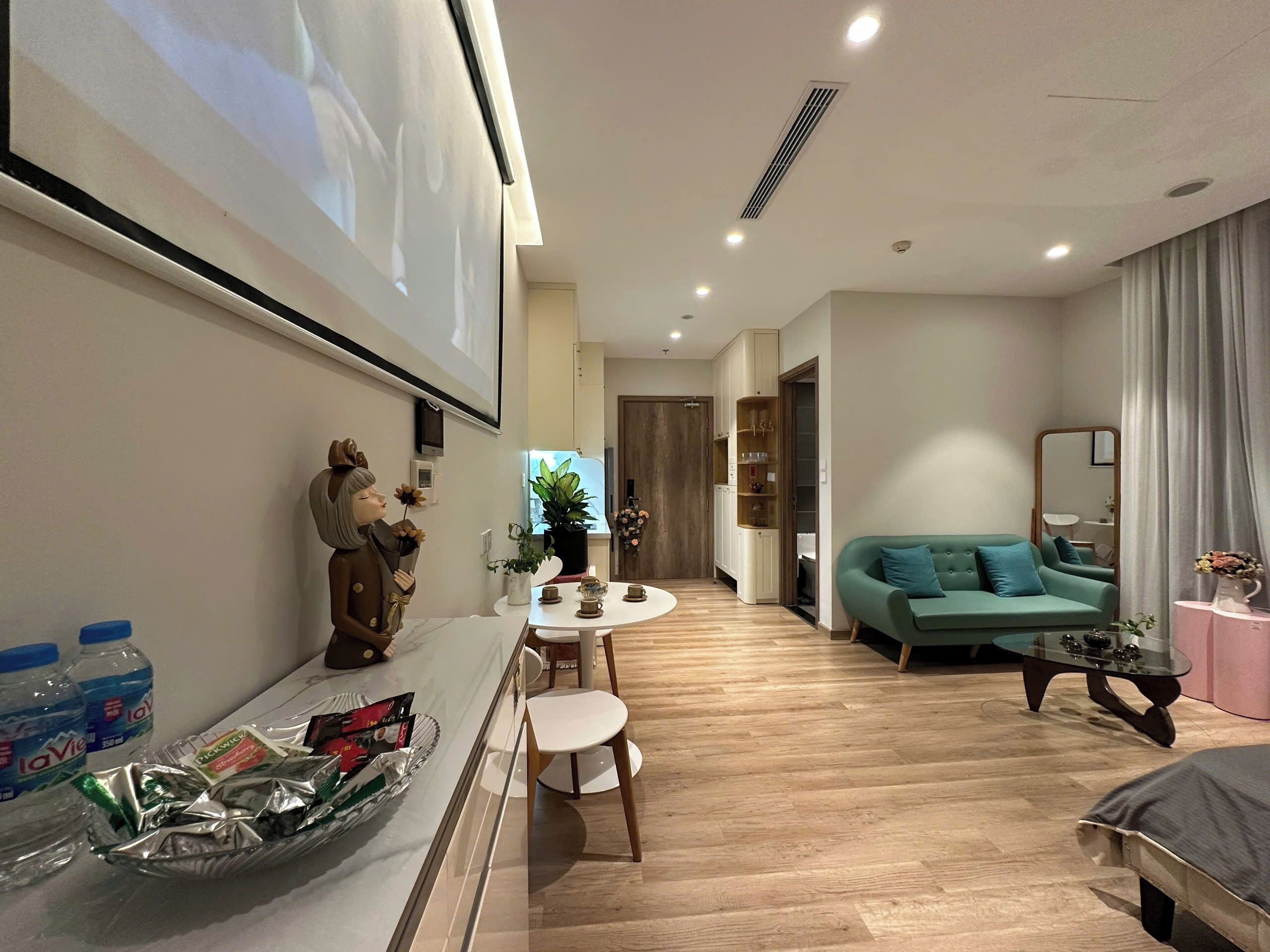 A modern living room with a sofa, a coffee table, and a dining area with a table and chairs.