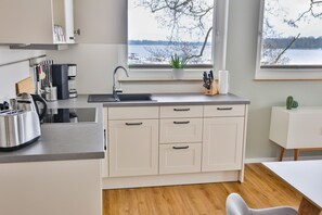 A modern kitchen with a sink, countertop, and cabinets.