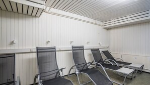 A room with white paneled walls, a tiled floor, and four reclining chairs with metal frames and mesh backs. - Apartment 'Terrassenpark 160' with Mountain View, Balcony and Wi-Fi (Schonach)