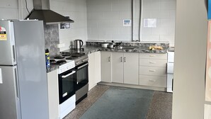 A kitchen with a refrigerator, stove, oven, and cabinets. - Green Hayes Estate Rentals - R5 Magnolia House in quiet peaceful country setting (Temuka)