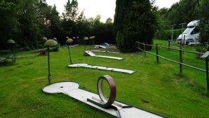 An outdoor sculpture garden with abstract metal structures and pathways. - Holiday Home in Elim near Slagharen Park (Elim)