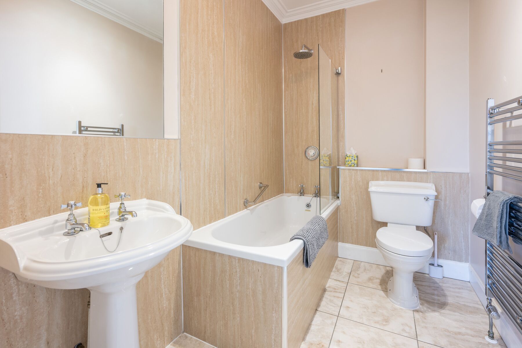 Un baño con lavamanos doble, bañera y retrete.