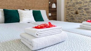 A neatly made bed with folded white towels and a decorative pillow with text. - Apartment in Mezzolago by Lake Ledro (Mezzolago (TN))