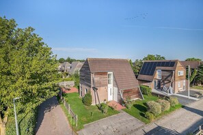 A residential area with houses featuring sloped roofs and solar panels.
