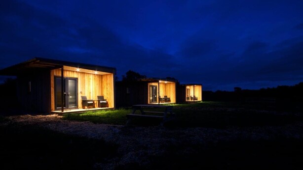 Three wooden cabins with open fronts, each with a table and chairs outside. - Paulton - Sleeps 2 - Petfriendly - Hottub - Garden (Bristol)