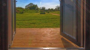 An open wooden door leading to a grassy outdoor area with a clear sky. - Paulton - Sleeps 2 - Petfriendly - Hottub - Garden (Bristol)