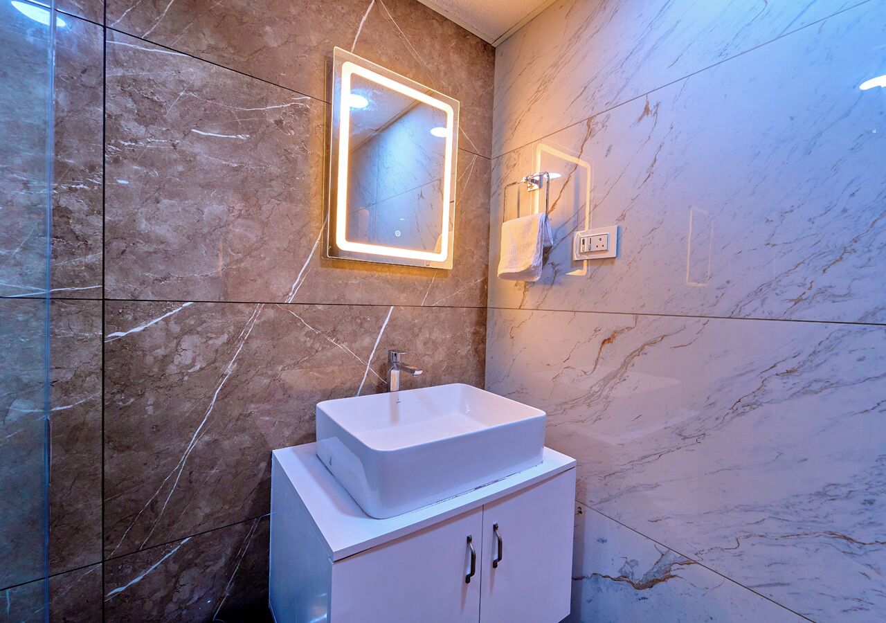 A bathroom with a white sink, a mirror, and a towel rack.