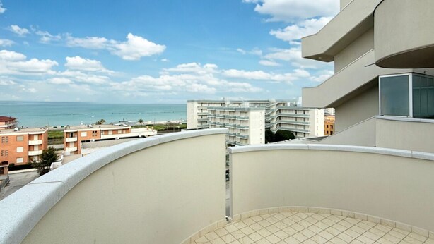 A balcony with a view of the sea and other buildings. - SE164 - Marotta, Three-Room Apartment with Sea View and Terrace (Marotta)
