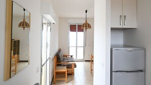 A room with a bed, a desk, a chair, a mirror, a wardrobe, and a refrigerator. - SE164 - Marotta, Three-Room Apartment with Sea View and Terrace (Marotta)