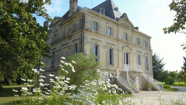 A large, historic building with a symmetrical facade, multiple windows, and a central staircase leading to a balcony. - Your Château in the vineyards near Bordeaux (Arveyres)