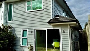 A two-story house with a wooden deck, a sliding glass door, and a small patio area. - Newly Built 3 BDMs Besides Chartwell Shopping Mall (Hamilton)