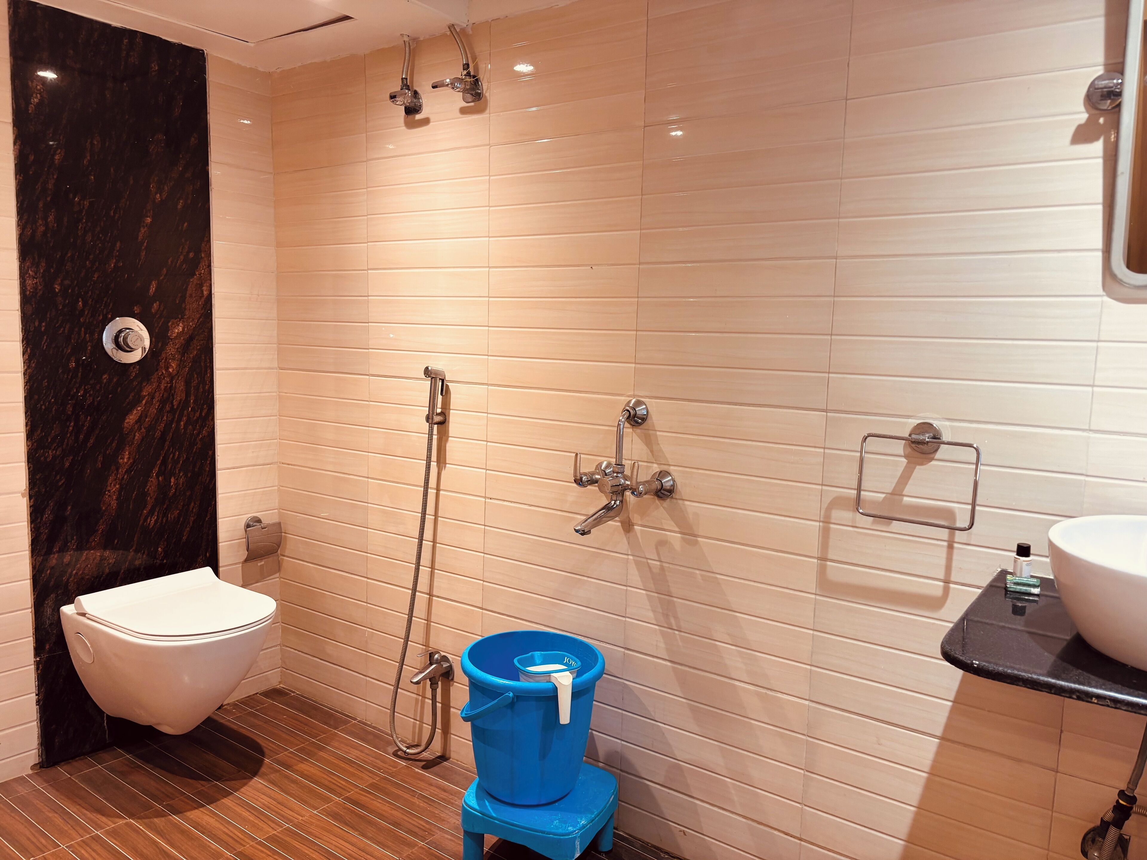 A modern bathroom with a toilet, bidet, and shower.