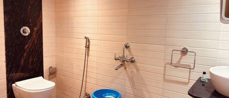 A modern bathroom with a toilet, bidet, and shower.