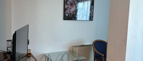 A modern office space with a desk, computer, and chair.