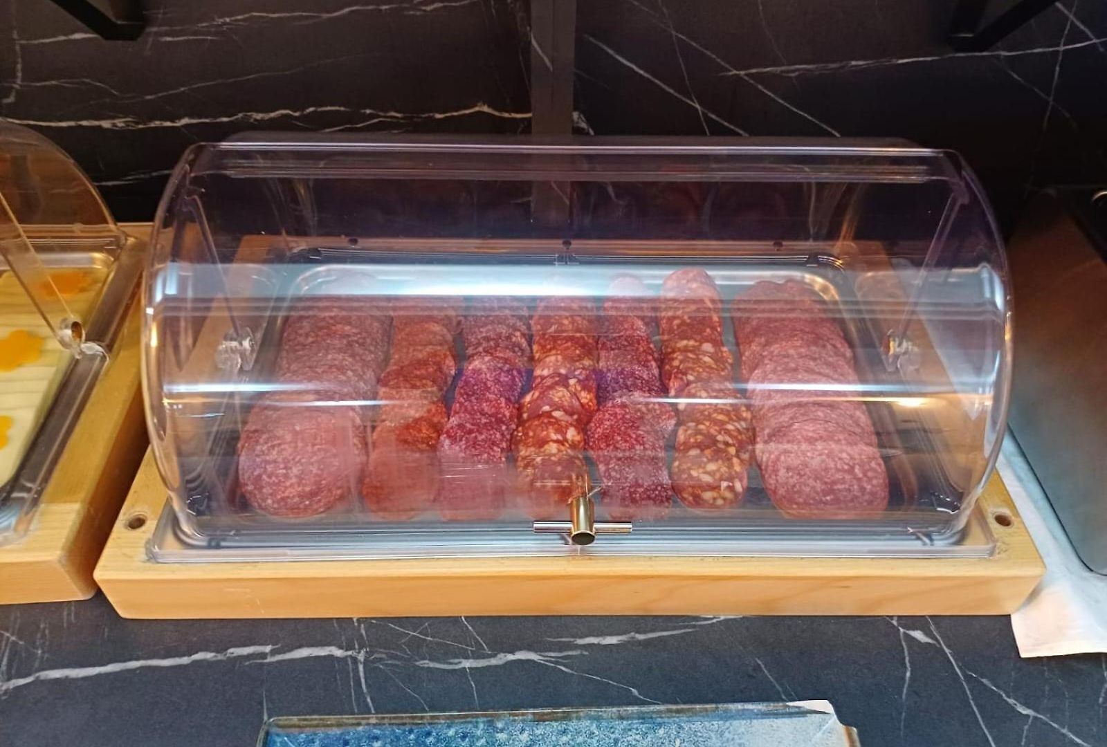 A display case containing various types of cured meats.