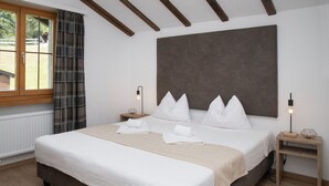 A bedroom with a large bed, two bedside tables, a window with curtains, and a headboard. - Lovely apartment for 4 people with WIFI, pool, TV, balcony, pets allowed and panoramic view (Falera)