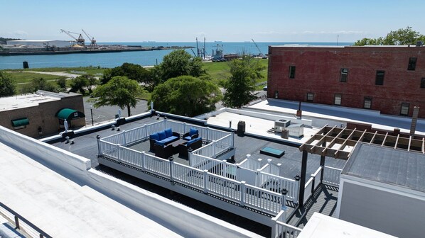Enjoy breathtaking harbor views from this rooftop terrace with a seating area and stunning cityscape.