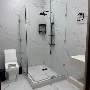 Shower, hair dryer, slippers, towels