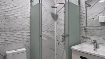 Shower, hair dryer, slippers, towels