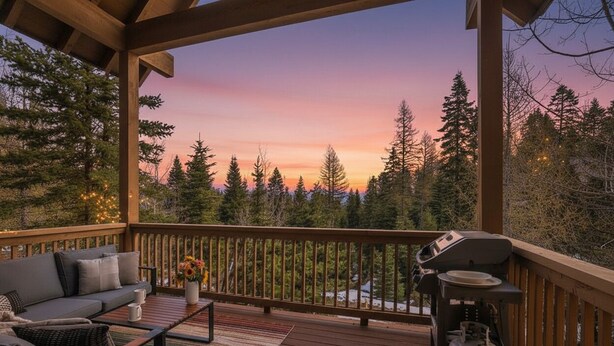 A covered deck with a sofa, a grill, and a gas tank.