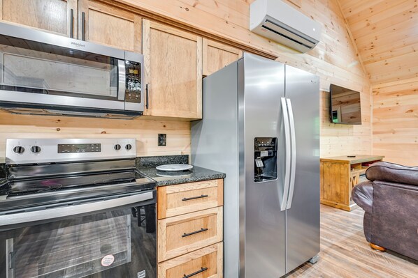 A compact kitchen with a stainless steel refrigerator, microwave, and stove. - 5 Mi to Mammoth Cave: Peaceful Retreat w/ Fire Pit (Cave City)