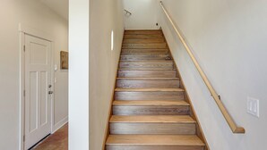 A staircase with wooden steps and a wooden handrail, leading to a door at the top. - Home 21 Mi to Glacier Nat'l Park: Boat, Fish, Hike (Columbia Falls)
