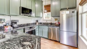 A kitchen with green cabinets, a stainless steel refrigerator, a microwave, and a coffee maker. - 2 Mi to L'auberge Casino: Home w/ Large Yard! (Baton Rouge)
