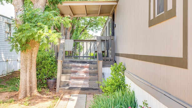 A covered outdoor staircase leading to a house with a porch. - 13 Mi to Okc: Edmond Home w/ Pool Access! (Edmond)