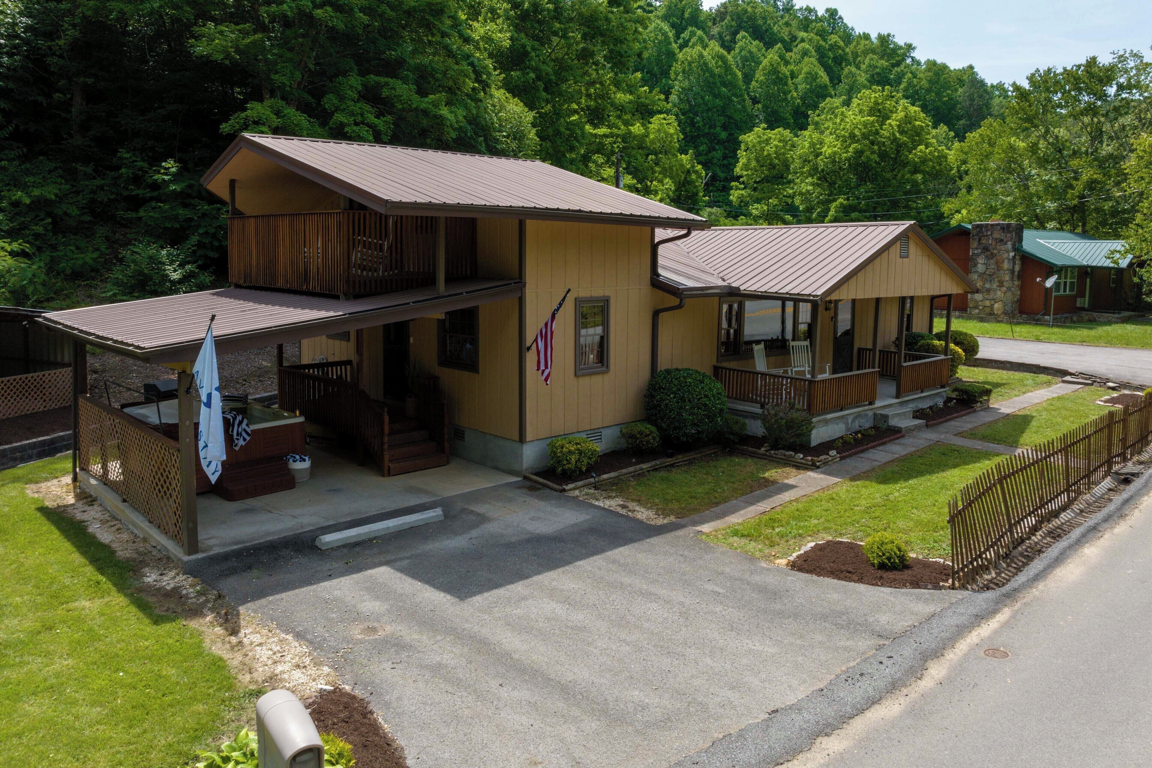 A two-story lodge with a porch and a flag.