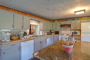 A kitchen with white cabinets, a granite countertop, and a microwave. - Dog-friendly! Near Cooperstown, Hiking & Golfing (Cherry Valley)