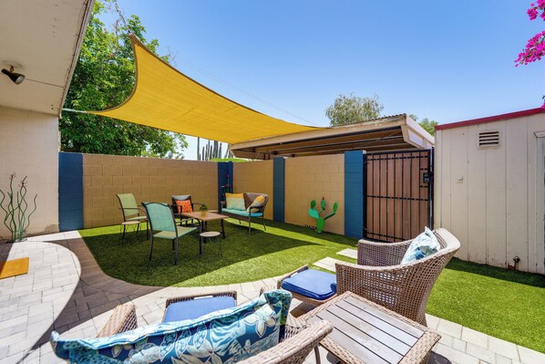 A patio with wicker furniture, a yellow shade, and a cactus decoration. - 1.5 Mi to Old Town Scottsdale: Unit w/ Fenced Yard (Scottsdale)