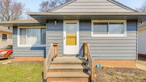 A two-story house with a front porch, a garage, and a brick foundation. - 8 Mi to Dtwn Cleveland: Quiet Home w/ Fenced Yard (Garfield Heights)
