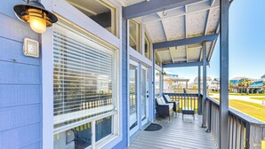 A covered porch with a railing, a bench, and a table. - Walk to Beach: Ocean-view Home w/ Deck in Freeport (Freeport)