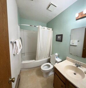 A bathroom with a shower, toilet, sink, and a towel rack. - Unit 531 - Standard Condo (Winter Park)