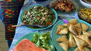 A buffet table with various dishes, including a salad, samosas, and other foods. - Kalk Bay Condo at The Majestic (Cape Town)