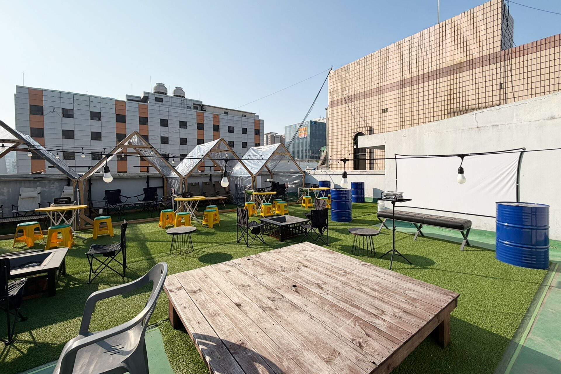 An outdoor seating area with tables, chairs, and umbrellas.
