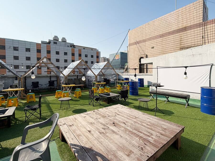 An outdoor seating area with tables, chairs, and umbrellas.