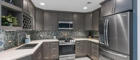 Fridge, microwave, coffee/tea maker, cookware/dishes/utensils