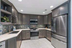 Fridge, microwave, coffee/tea maker, cookware/dishes/utensils