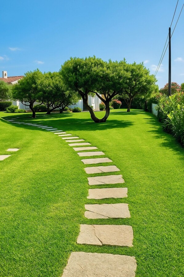 A well-maintained garden with a stone pathway leading through it.