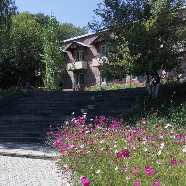 A building with a sloped roof and a staircase leading up to it.