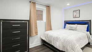 A bedroom with a bed, a dresser, and a window with curtains. - Charming 2-bedroom apartment in fabulous Chicago with WiFi, Game Space (Chicago)