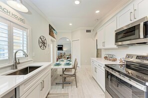 Fridge, microwave, stovetop, dishwasher - Palm Isle Village 3208 - Charming Beachside Condo | Island Real Estate (Holmes Beach)